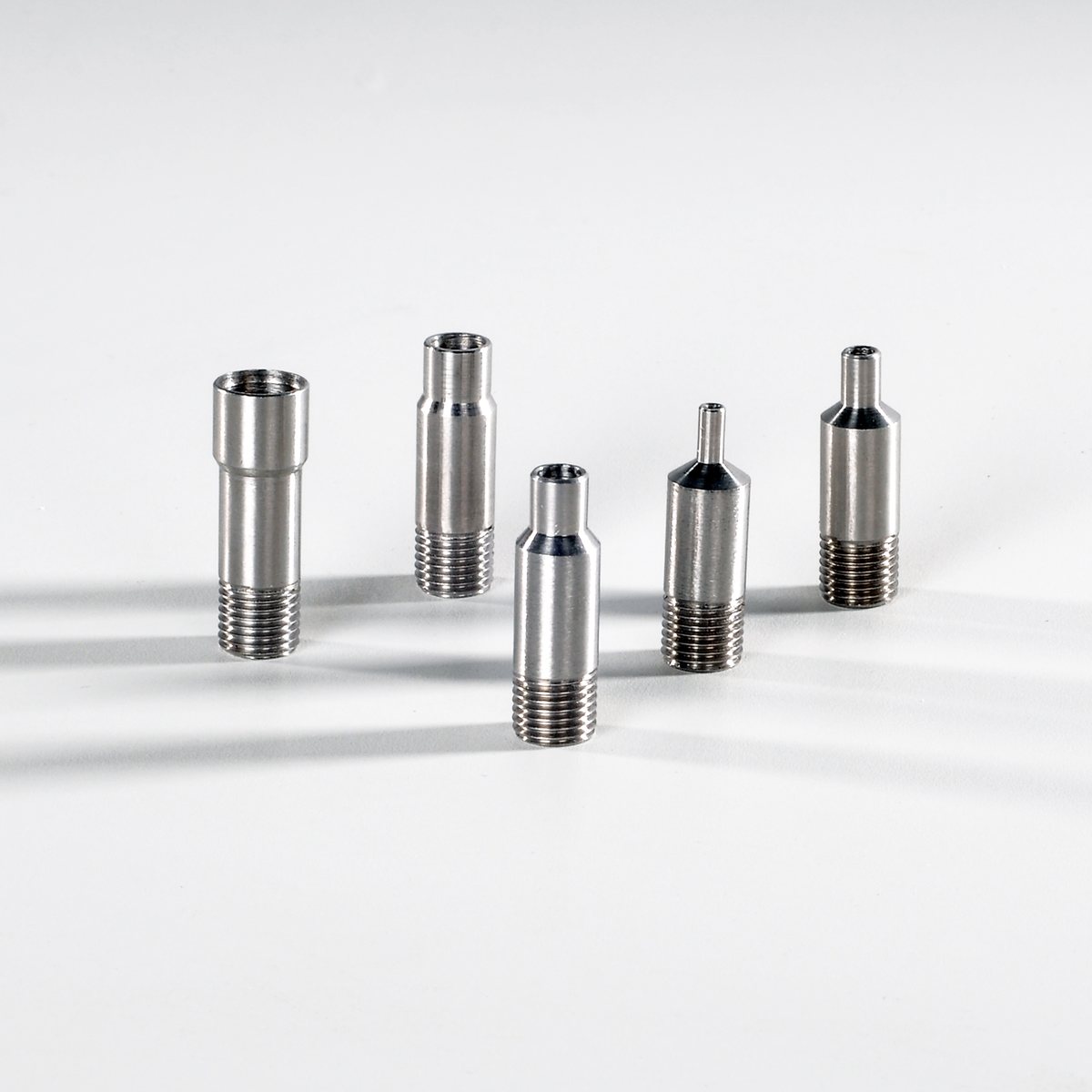 Six threaded transition fittings in stainless steel